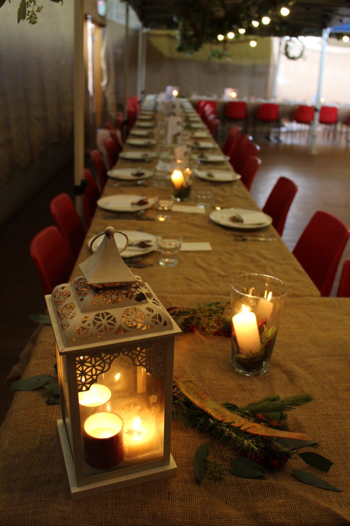 Table settings with lights, lanterns and candles add to the ambience at the Harrow Long Lunch by Kate Eats